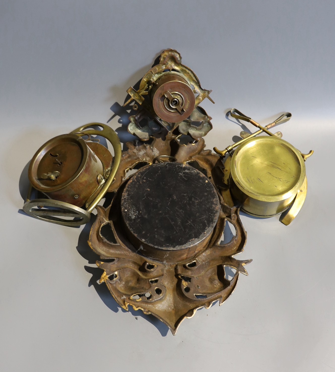 Two Edwardian brass horseshoe desk timepieces, one cast with fox head and folded crops, together with a smaller brass desk timepiece and one other, tallest 17cm